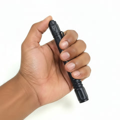 Hand holding a black flashlight with visible branding on a white background