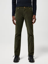 Person wearing olive green pants on a white background