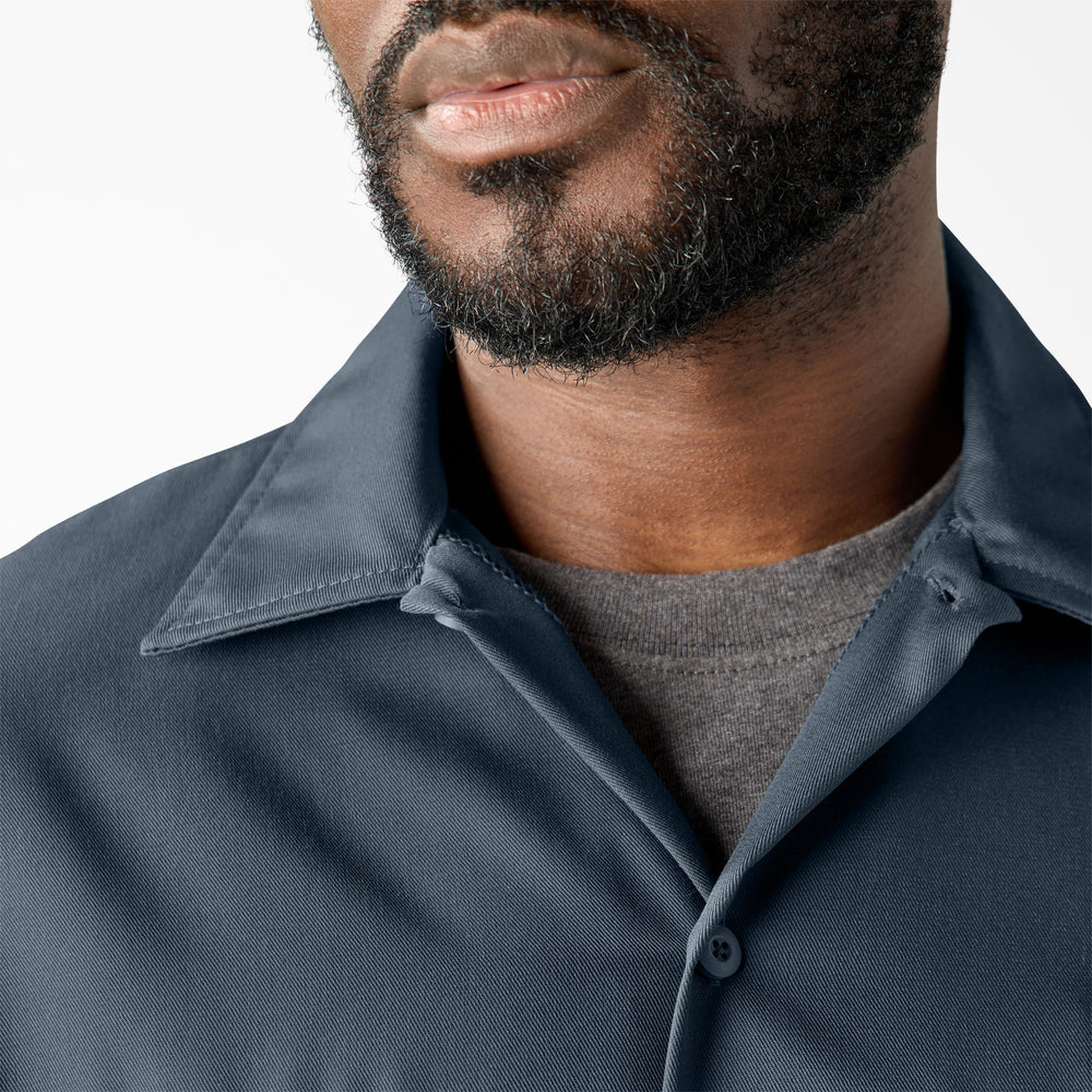 Man wearing a dark gray shirt with a close-up of the collar.