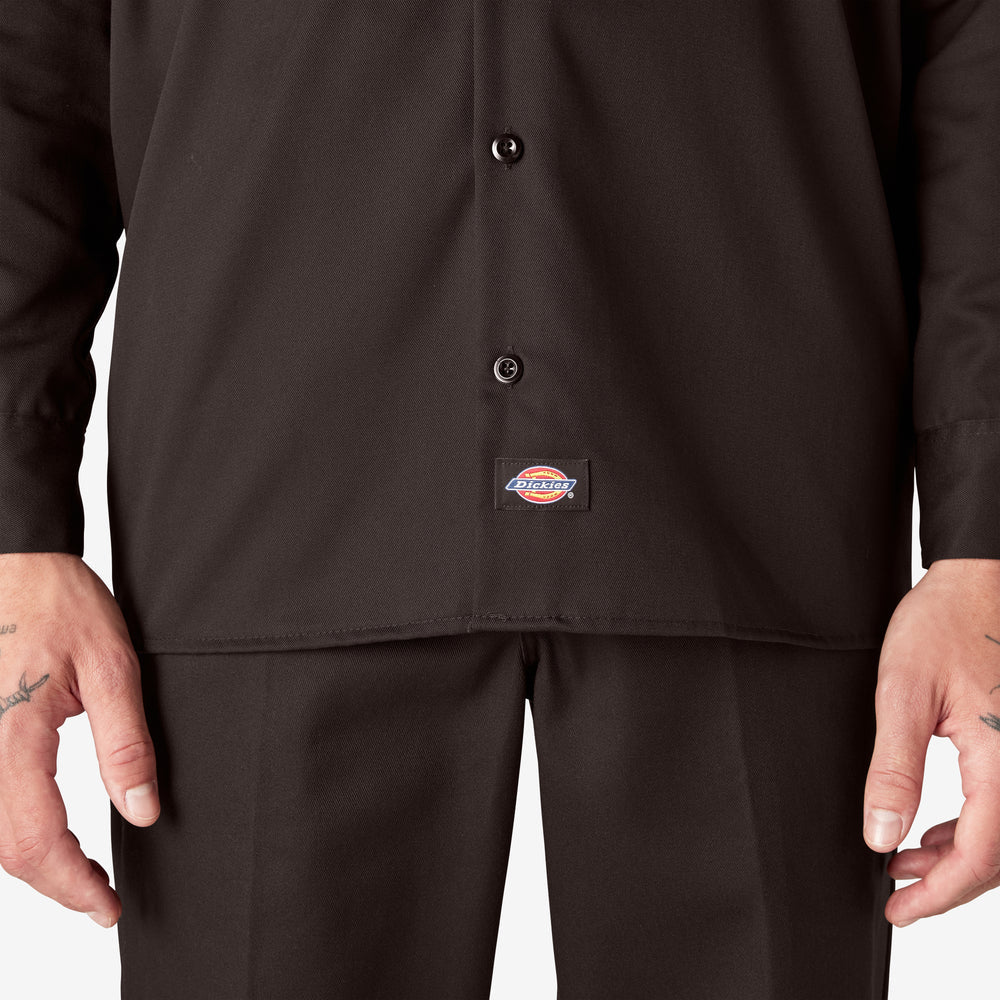 Person wearing a black shirt with a Dickies logo on a white background