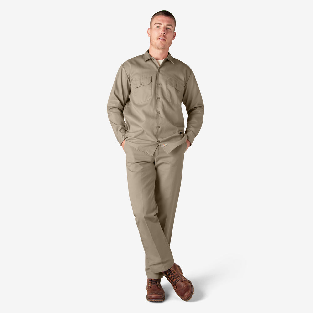Man wearing a beige work jumpsuit on a white background