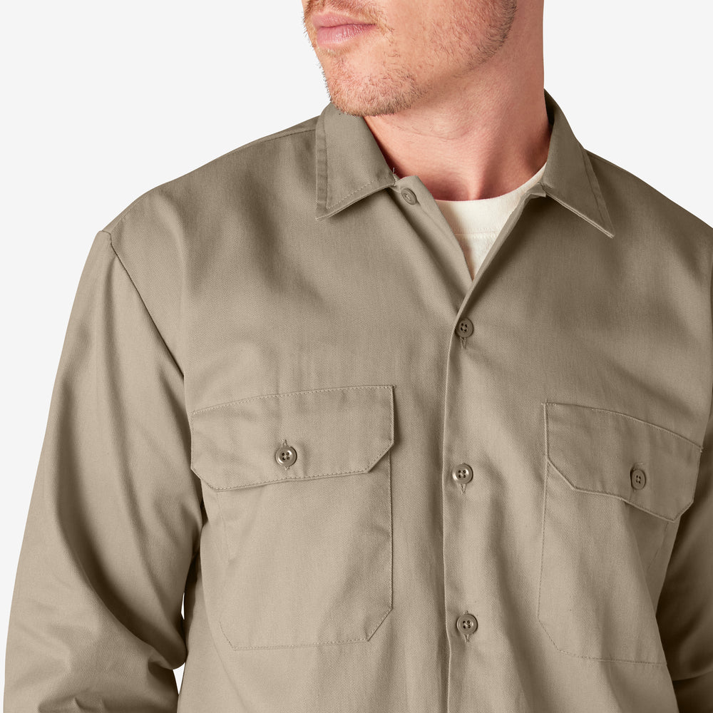 Beige button-up shirt worn by a person on a white background