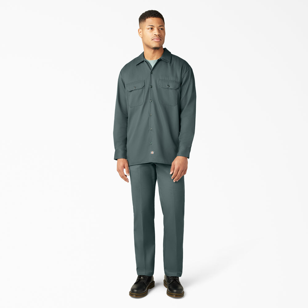 Man wearing a green shirt and pants on a white background