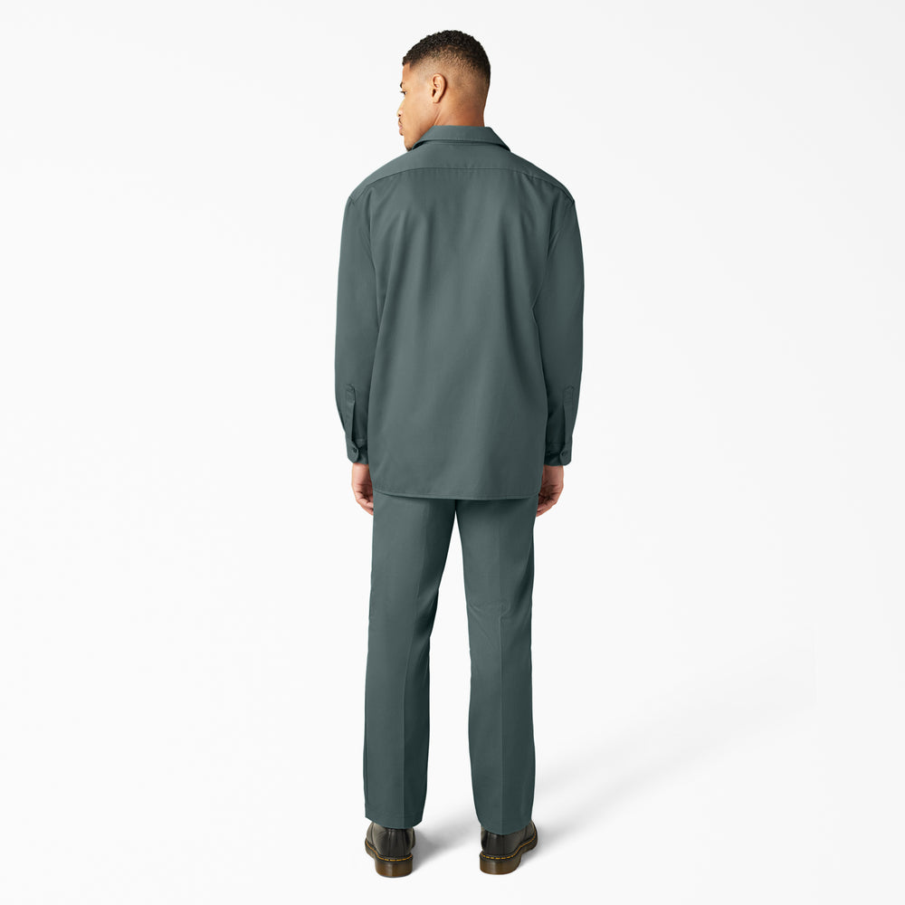 Man wearing a green shirt and pants on a white background