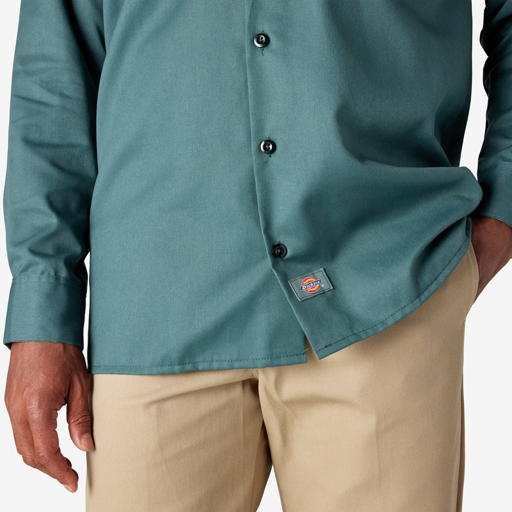 Teal button-up shirt with a logo on a white background