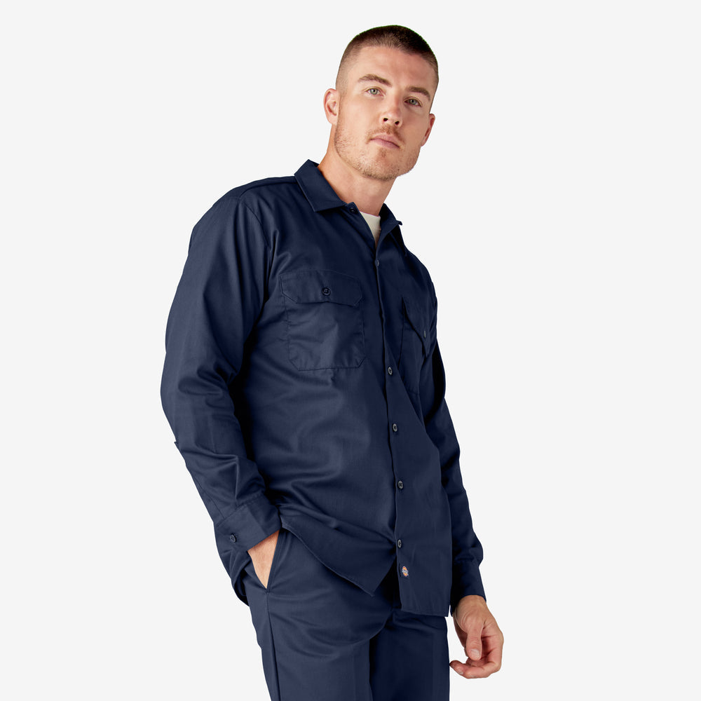 Man wearing a navy blue shirt and pants on a white background