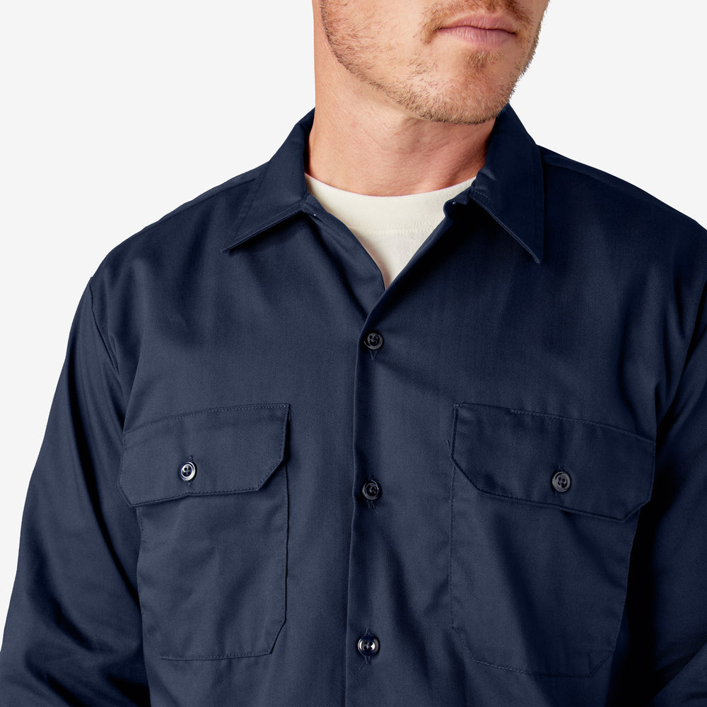 Navy blue shirt worn by a person on a light gray background