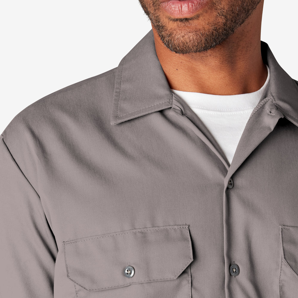 Close-up of a gray shirt worn by a person on a white background