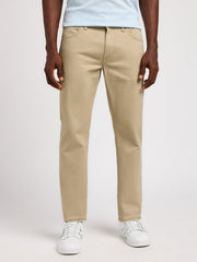 Person wearing beige pants and white sneakers on a white background