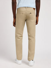 Person wearing beige pants on a white background