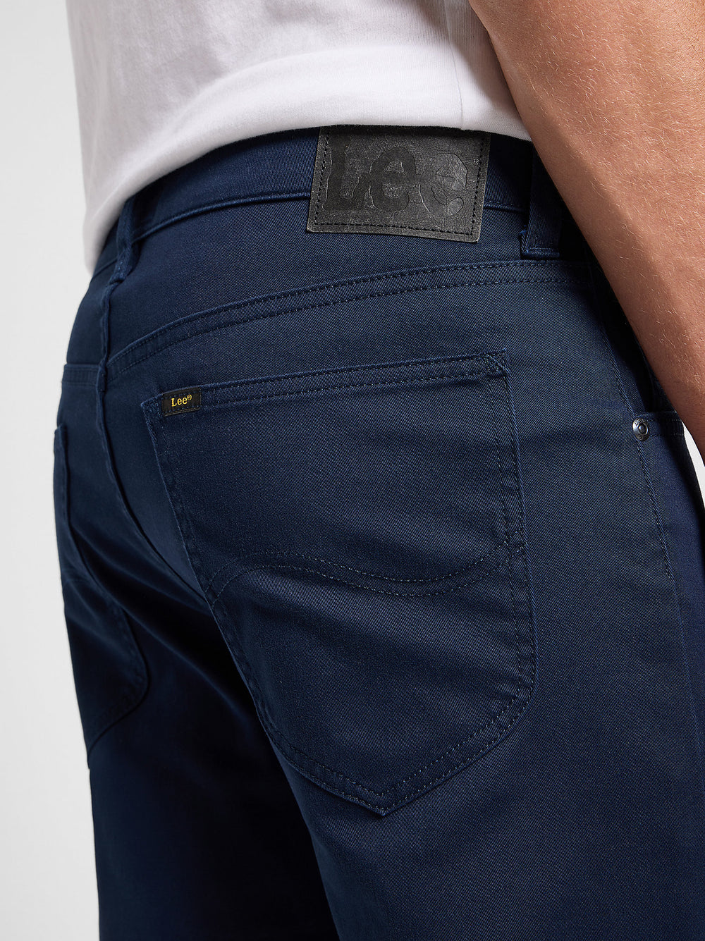 Navy blue pants with a brand label on a white background