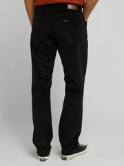 Person wearing black pants on a plain background