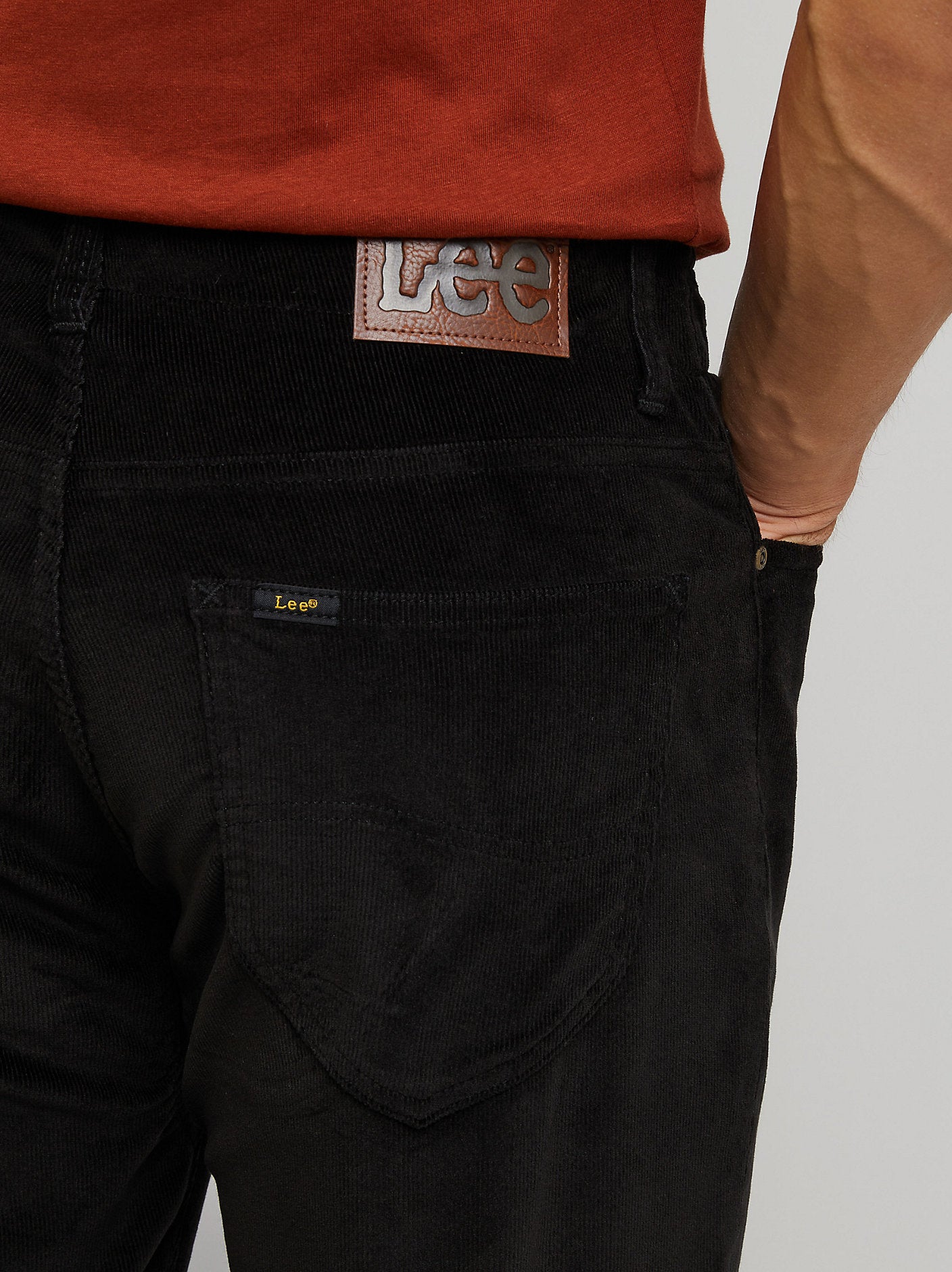 Black pants with Levi's branding on a gray background