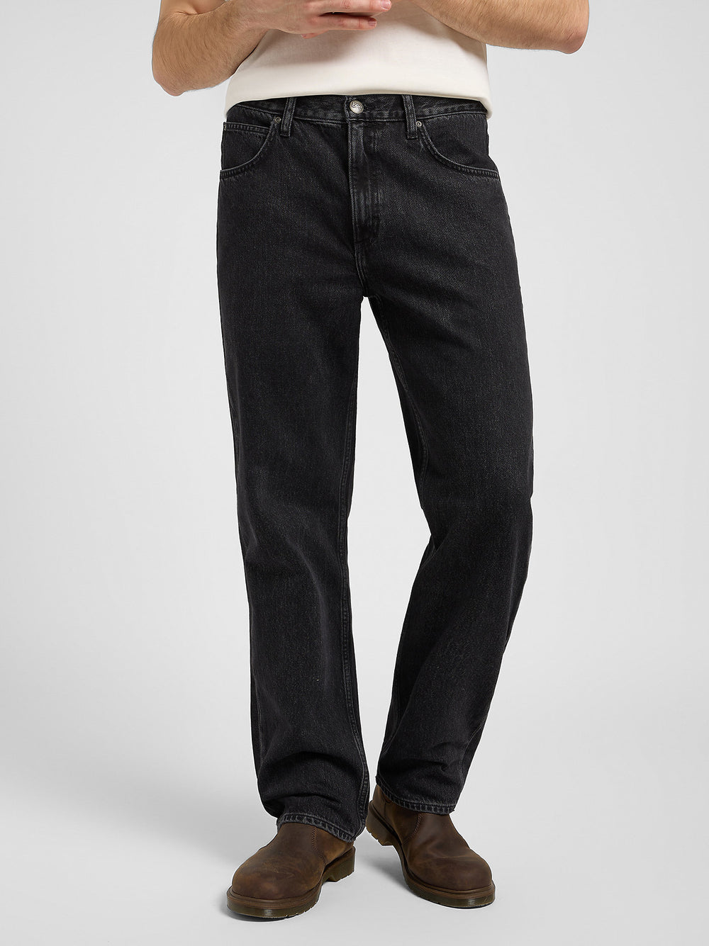 Person wearing black jeans on a white background