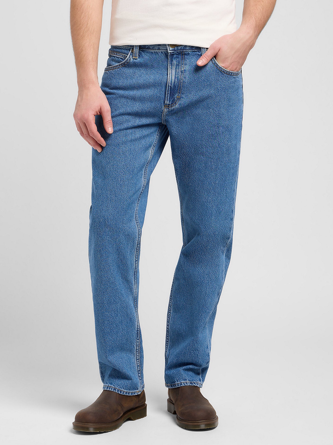 Person wearing blue jeans on a white background