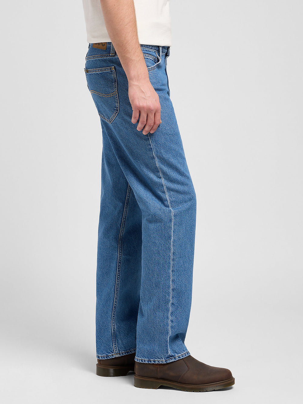 Person wearing blue jeans on a white background