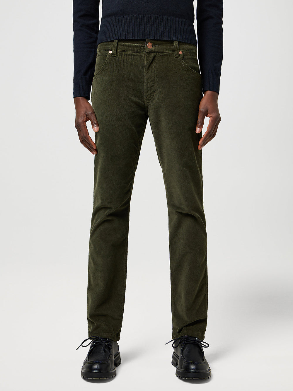 Person wearing olive green pants on a white background