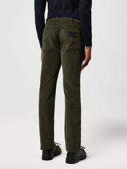 Person wearing olive green pants on a white background