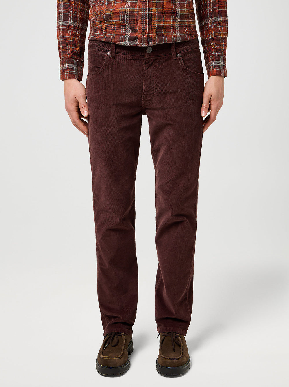 Person wearing brown pants and a plaid shirt on a white background