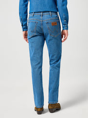 Person wearing blue jeans on a white background